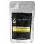 Silver pouch against white background with black label. Yellow rectangle with black lettering reads "Ultra Bonding Adhesive For Eyelash Extensions Banana Scented"